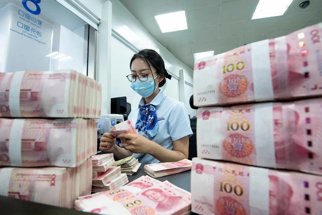 A young woman counting chinese yaun note