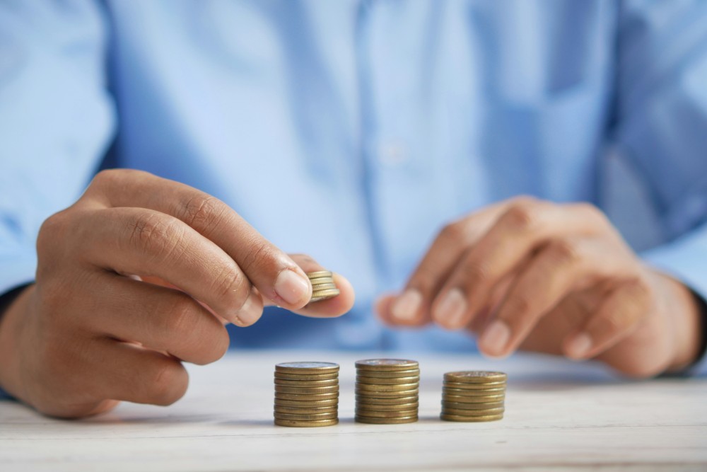 Hand on stack coins