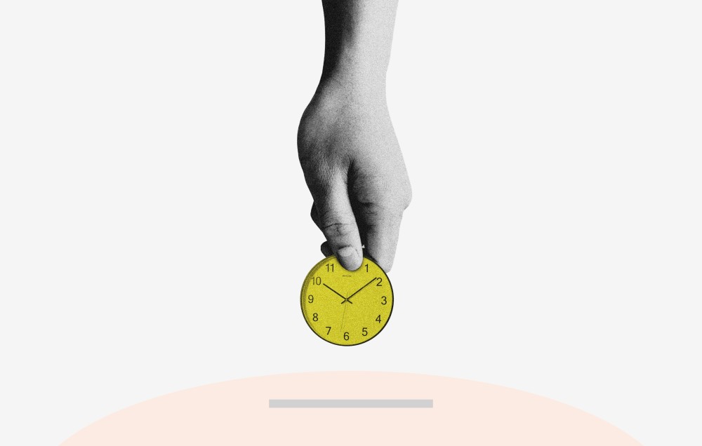 A hand holding a coin like watch